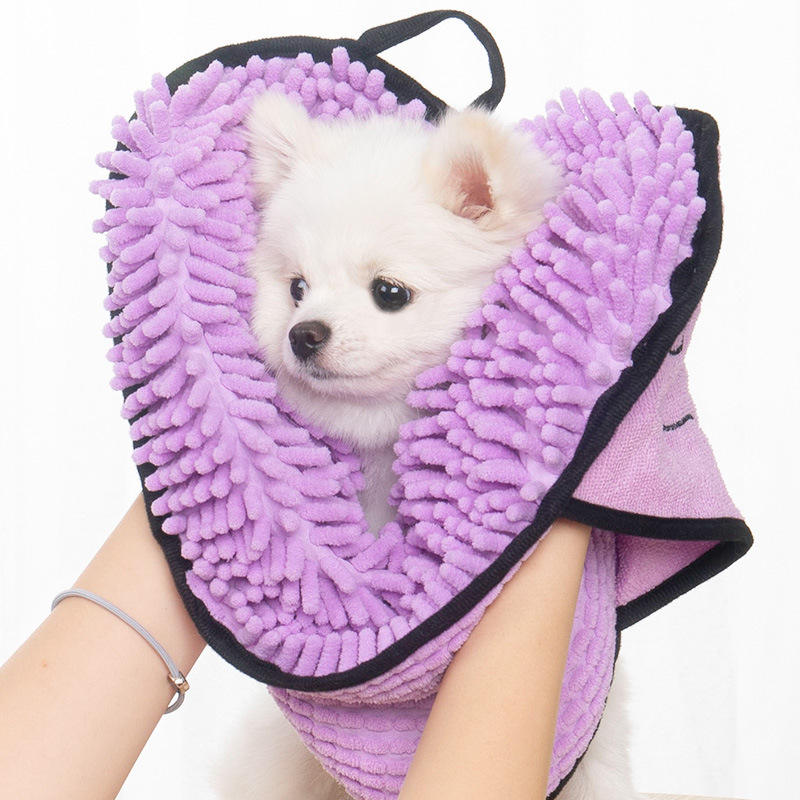 Small dog wrapped in purple chenille pet drying towel