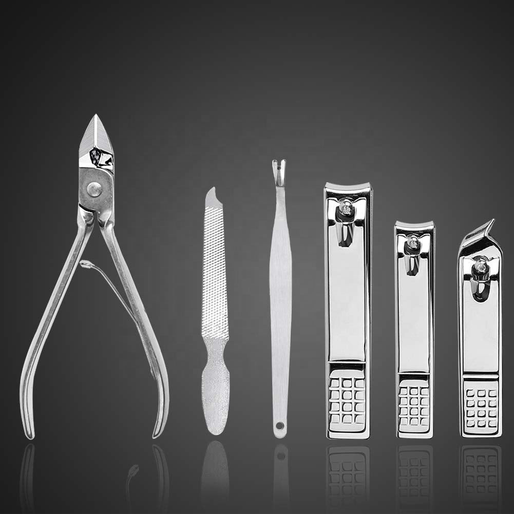 Close-up of stainless steel nail clippers, file and cuticle tools