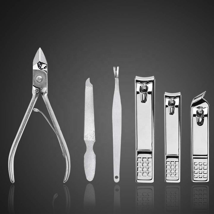 Close-up of stainless steel nail clippers, file and cuticle tools